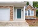 Close up of the front door to the home, the door is a dark teal with stone accents around it at 3514 Willgrove Way, Duluth, GA 30096