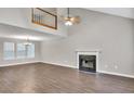 Spacious living room with wood floors, a fireplace, and a large window for ample natural light at 3514 Willgrove Way, Duluth, GA 30096