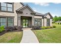 Charming front entrance with a modern door, wreath accents, and lush landscaping at 3991 Perry Pass, Lithonia, GA 30038