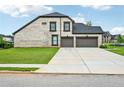 Spacious three-car garage with a long driveway and well-maintained lawn at 3991 Perry Pass, Lithonia, GA 30038