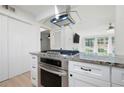 Well-equipped kitchen with stainless steel oven, smooth cooktop, and ample storage in white cabinets at 705 Country Park Se Dr, Smyrna, GA 30080