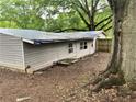 Side exterior view showing gray siding and backyard at 2135 Wells Se Dr, Smyrna, GA 30080
