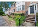 Close-up of townhouse entrance with well-kept landscaping, steps and black iron railing at 2349 Henderson Mill Ne Rd # 2, Atlanta, GA 30345