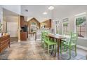 Dining area with green chairs, and tile floors, adjacent to the kitchen and living spaces at 2735 Royal Blf, Decatur, GA 30030