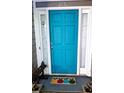 A close-up of a bright blue front door with pineapple-themed welcome mat at 2735 Royal Blf, Decatur, GA 30030