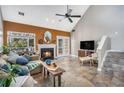 Cozy living room with a fireplace, tile flooring, and views of the lush greenery outside at 2735 Royal Blf, Decatur, GA 30030
