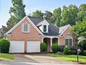 Charming brick home with a two-car garage and manicured landscaping at 3082 Monarch Pine Dr, Peachtree Corners, GA 30071