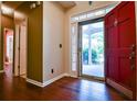 Bright foyer with red door, wood floors, and views of the landscaped front yard at 3082 Monarch Pine Dr, Peachtree Corners, GA 30071