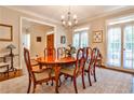 Bright dining room featuring an elegant chandelier, hardwood floors, and ample natural light at 4476 Paces Battle Nw, Atlanta, GA 30327