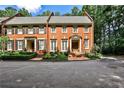 Traditional brick townhome with meticulously landscaped front yard and inviting entryway at 4476 Paces Battle Nw, Atlanta, GA 30327