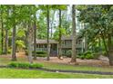 View of the two-story home with a welcoming front porch surrounded by mature trees at 944 Hardy Cir, Dallas, GA 30157