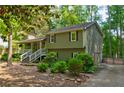 Exterior view of the two-story home with a front porch and manicured greenery at 944 Hardy Cir, Dallas, GA 30157
