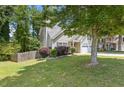 Landscaped front yard showcasing a well-maintained lawn, garden bed and two car garage at 109 Riley Way, Canton, GA 30115