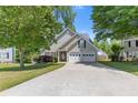 Charming home with a two-car garage and inviting front yard, offering curb appeal at 109 Riley Way, Canton, GA 30115