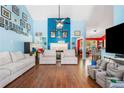 Expansive living room boasts hardwood floors, blue walls, and a cozy fireplace at 1162 Apalachee Run Trl, Dacula, GA 30019