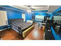 Spacious bedroom features hardwood floors, tray ceilings, and a ceiling fan at 1162 Apalachee Run Trl, Dacula, GA 30019