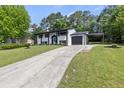 Stylish home with a long driveway, carport, and freshly landscaped front yard at 1253 Willow Dr, Riverdale, GA 30296