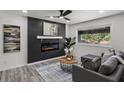 Cozy living room featuring a modern fireplace, sleek ceiling fan, and stylish decor at 1253 Willow Dr, Riverdale, GA 30296