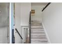 Inviting staircase with light wood steps and a dark wood handrail at 1253 Willow Dr, Riverdale, GA 30296