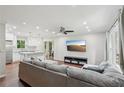 Spacious open concept living room with hardwood floors, a modern ceiling fan, recessed lighting, and seamless kitchen access at 2156 Doris Dr, Decatur, GA 30034