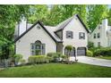 Charming two-story home featuring a painted brick facade, black trim, and well-manicured landscaping at 1810 Fairoaks Pl, Decatur, GA 30033