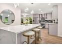 Stylish kitchen featuring a marble island with seating, modern lighting, and stainless steel appliances at 1810 Fairoaks Pl, Decatur, GA 30033