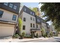 Attractive townhome with a garage and stylish white brick and dark accents at 1821 Huntington Hills Nw Ln, Atlanta, GA 30309