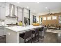 Modern kitchen featuring a spacious island with seating, stainless steel appliances, and stylish backsplash details at 1821 Huntington Hills Nw Ln, Atlanta, GA 30309