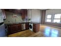 Open-concept kitchen with a washer/dryer combo, stainless steel appliances and hardwood floors at 20 Marietta Nw St # 16A, Atlanta, GA 30303
