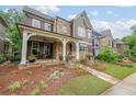 Charming home with a rocking chair front porch and manicured lawn at 423 Hunt Ne St, Marietta, GA 30060