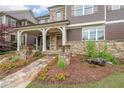 Inviting home with stone details, rocking chair porch, and stone pathway at 423 Hunt Ne St, Marietta, GA 30060