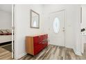 Bright foyer with striking floors, decorative front door and stylish red cabinet at 509 Roy Sw St, Atlanta, GA 30310