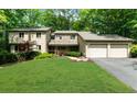 Beautiful home featuring stone accents, an attached two-car garage, and a well-manicured front yard at 1665 Chevron Way, Sandy Springs, GA 30350