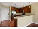 Kitchen with dark wood cabinets, stainless steel appliances, and an island with countertop seating at 201 W Ponce De Leon Ave # 515, Decatur, GA 30030