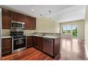 Cozy kitchen with stainless steel appliances, dark wood cabinetry, and an open-concept design at 201 W Ponce De Leon Ave # 515, Decatur, GA 30030