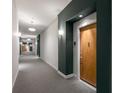 Hallway with carpet and white and dark-painted walls, with an apartment door at 870 Inman Village Pkwy # 203, Atlanta, GA 30307