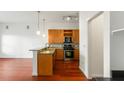Modern kitchen with granite countertops, stainless steel appliances, and wood cabinets at 870 Inman Village Pkwy # 203, Atlanta, GA 30307