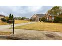 Well-kept single-Gathering home boasting a lush front lawn and a private driveway at 118 Jasmine Way, Carrollton, GA 30180