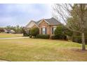 Lovely single-story brick home featuring dark shutters and verdant landscaping at 118 Jasmine Way, Carrollton, GA 30180