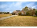 Brick home on large lot shows long driveway, with neat landscaping and plenty of space around the property at 118 Jasmine Way, Carrollton, GA 30180