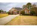 Inviting single-Gathering home featuring a well-maintained lawn and a long, concrete driveway at 118 Jasmine Way, Carrollton, GA 30180