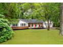 Charming ranch style home with a well-manicured lawn and inviting front porch with wood columns at 2221 Meadow Wood Ct, Marietta, GA 30062