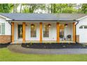 Inviting front porch with stylish chairs, hanging planters, and decorative wooden columns at 2221 Meadow Wood Ct, Marietta, GA 30062