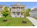 Beautiful two-story home with a double balcony, a well-kept lawn, and a welcoming front porch at 2342 Terrace View Sw Cir, Atlanta, GA 30315