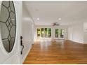 Bright and spacious living room featuring hardwood floors and multiple doors to the outdoor deck at 1865 Briarlake Cir, Decatur, GA 30033