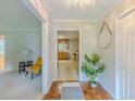 Warm foyer with hardwood floors, view to kitchen, and decorative mirror, creating a welcoming entry at 5841 Covered Wagon Trl, Lilburn, GA 30047