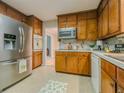 Functional kitchen featuring stainless steel appliances and wood cabinets, perfect for home cooking at 5841 Covered Wagon Trl, Lilburn, GA 30047