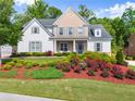 Charming two-story home with beautiful landscaping at 5875 Windjammer Pt, Cumming, GA 30041