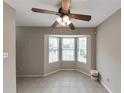 Bright living area featuring tiled floors, bay window and a ceiling fan, providing ample natural light at 8541 Westchester Dr, Douglasville, GA 30134