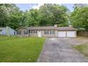 Traditional home featuring a two-car garage, dark shutters and green grass at 103 Sir Gregory Nw Mnr, Lawrenceville, GA 30044